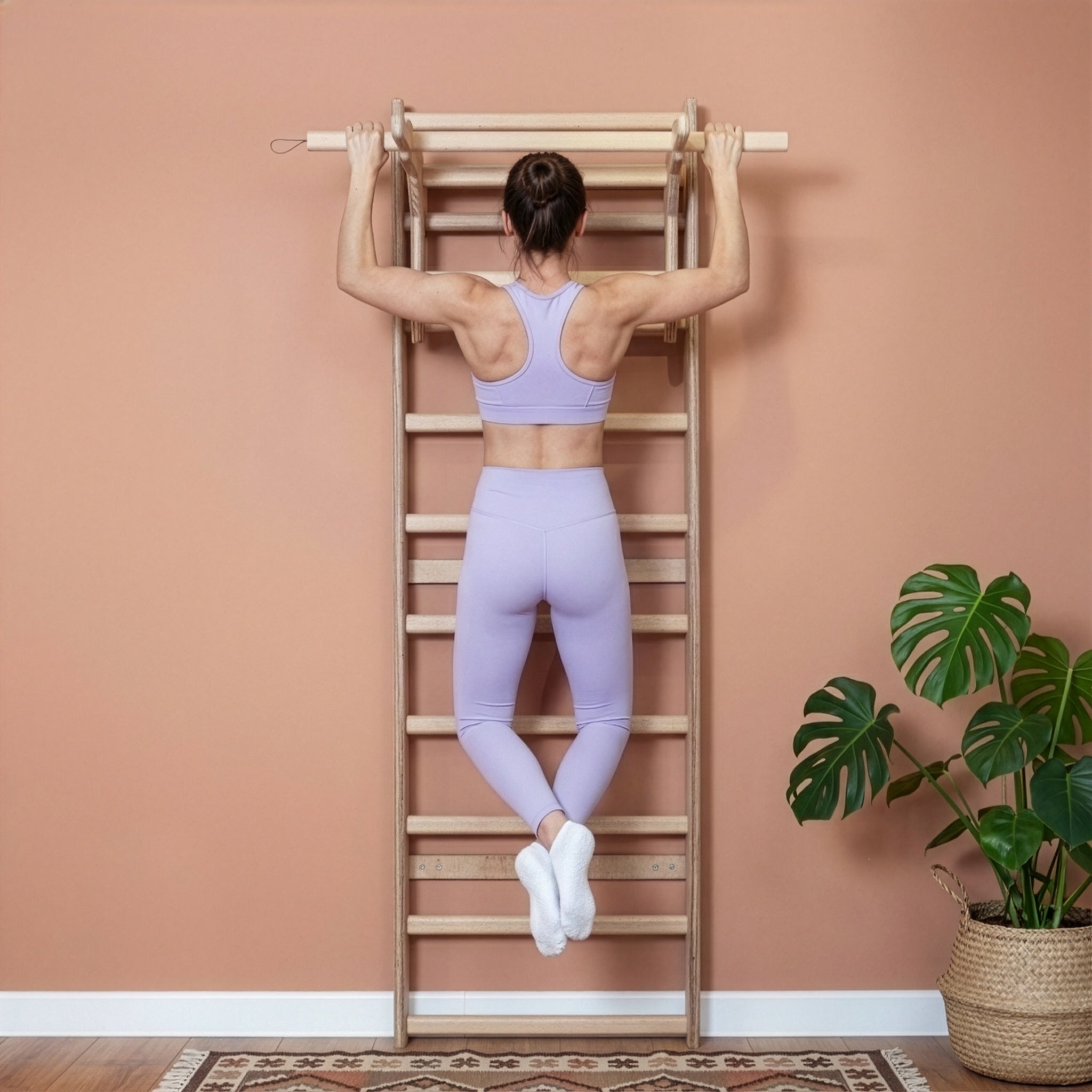 Fit model performing calisthenics exercises on a MowoFit modular wall bar, showcasing the premium handcrafted solid Beech wood design in a modern minimalist space.
