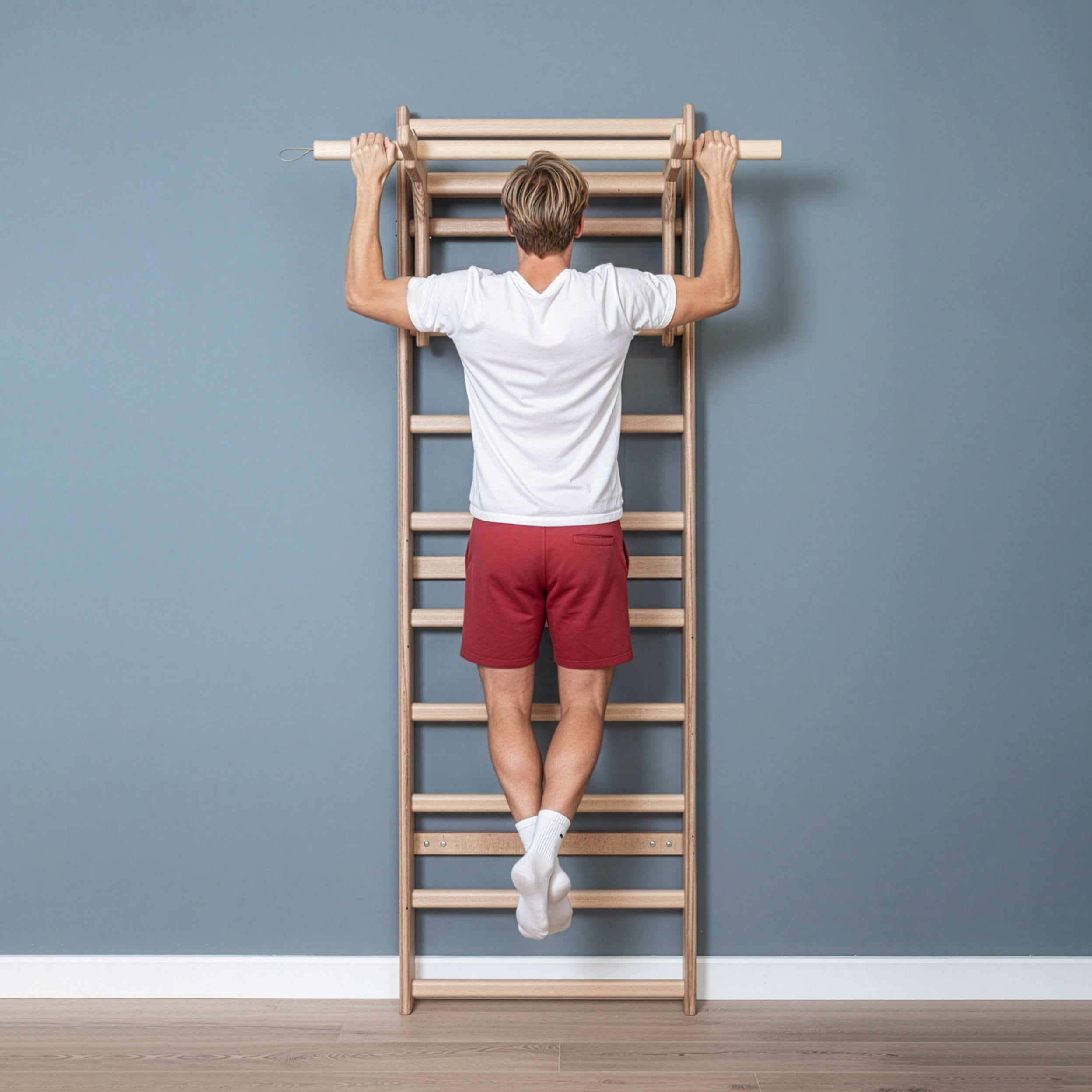 Fit model performing calisthenics exercises on a MowoFit modular wall bar, showcasing the premium handcrafted solid Beech wood design in a modern minimalist space.