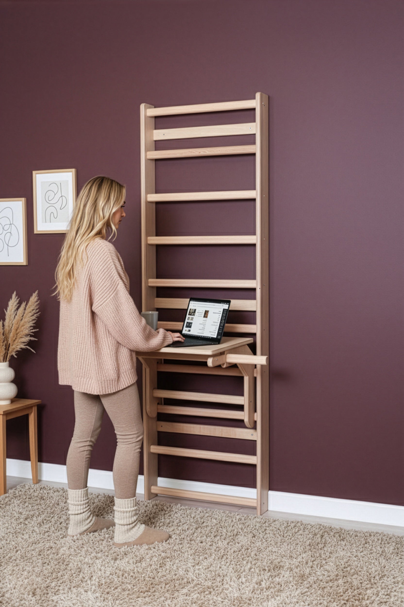 User utilizing the MowoFit Wall Bar as an ergonomic wooden standing desk, highlighting the space-saving design and premium craftsmanship for remote work setups.